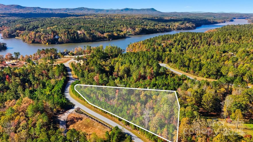 Discover the perfect blend of privacy, luxury, and natural beauty with this 3+ acre lot in the gated community of Edgewater located at Lake Rhodhiss. This parcel offers a prime opportunity to build your dream home or weekend retreat. Enjoy the best of lakefront community living with the neighborhood common area which features private amenities, including a covered pavilion, fire pit, and picnic area. Conveniently located near Hickory, Morganton, and Lenoir, this property provides easy access to shopping, dining, and entertainment while maintaining a peaceful, secluded feel. *lot not suitable for conventional septic system.  Consult soil scientist for more options*