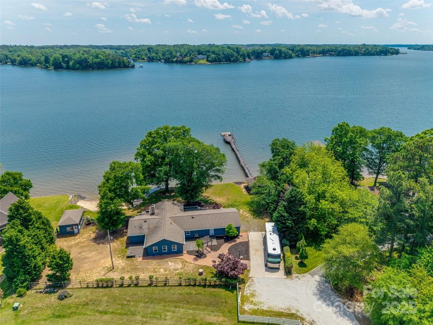 Welcome to life on the main channel of Lake Wylie—where the water is wide, views are big & the lifestyle is even better. This lakefront ranch sits on a flat lot w/ a private beach & room to swim, fish or enjoy your boat right from home. Whether you're grilling in the enclosed picnic area, reading in the gazebo or spending the day on the water, every inch of this property is made for making memories. The home is move-in ready with fresh paint, updated kitchen & a family room addition that gives you extra space to spread out. Outside, there’s a separate RV/Boat pad— bc lake life doesn’t end at the shoreline. All of this, with no HOA & access to top rated Clover schools and seller is offering 25K in dock repair concessions. A home with personality & a view to match—priced right for someone ready to add their own touch by the water. Love what you see? You’ll love it more in person. Set a time to see it today!
