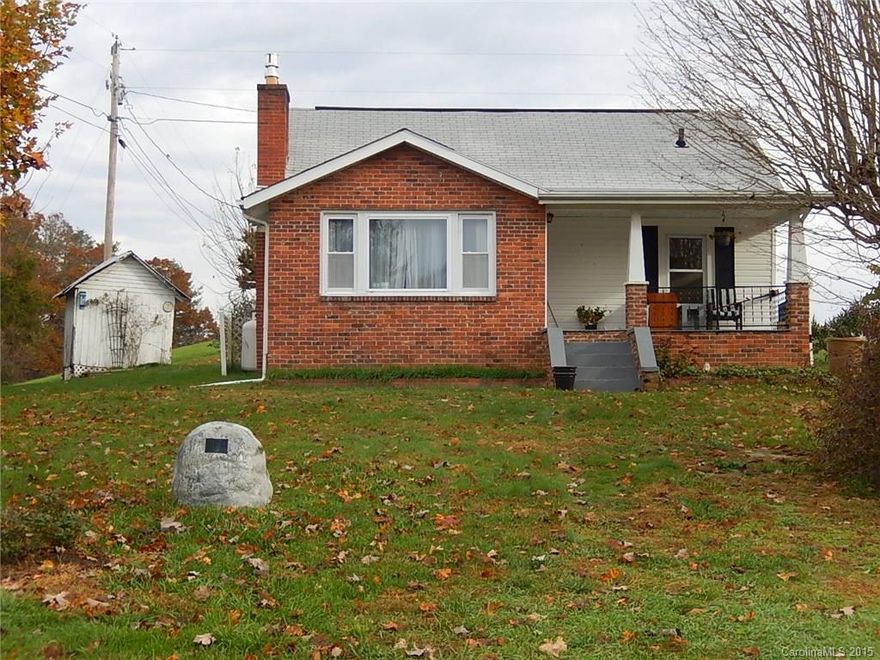Cozy and sweet 1927 farm house updated to 1970s. Two bedroom and one full bath on main and 270 square foot finished attic. Laundry in basement with outside entrance. Has two story workshop/converted garage, two car metal carport and outbuilding. Peaceful agricultural setting with lovely old trees and vines and views on dead end road. 15 minutes to Asheville.