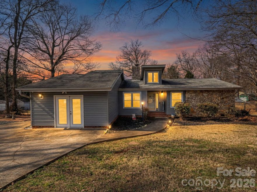 Sitting on two spacious lots in the Oakcrest subdivision and situated beside a cul-de-sac, this home offers both space and convenience. The large fenced yard provides plenty of room to enjoy the outdoors, complemented by a generous side and back deck perfect for relaxing or entertaining. The home features vinyl siding with stone accents and welcoming natural light through the foyer, creating an open feel with vaulted ceilings. The great room highlights a large stone gas fireplace as its centerpiece. The primary suite offers plenty of space with a large walk-in closet, tile shower, and soaking tub. A second bedroom and additional flex room provide great options for an office, hobby room, or guest space. An extra parking pad beside the driveway adds convenience, and two storage sheds convey with the property. Enjoy a quiet country feel while still having the benefits of a neighborhood setting.