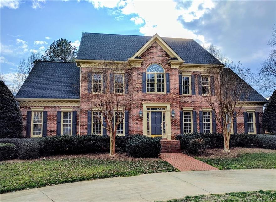 Stately traditional home on almost 1 AC lot with a 3 car garage.  This all brick home has 3 floors w/ master bedroom on first floor, 2 story foyer, library, formal dining room, large den w/ fireplace and huge kitchen w/ lots of cabinets.  Second floor offers 4 BR, 2 BA, recreation room and office.  Third floor - exercise and multipurpose rooms.  Crown molding and 9' ceilings.  Outside - large 2 level treated deck, attached yard equip storage, kid's treehouse/play area, and irrigation system.