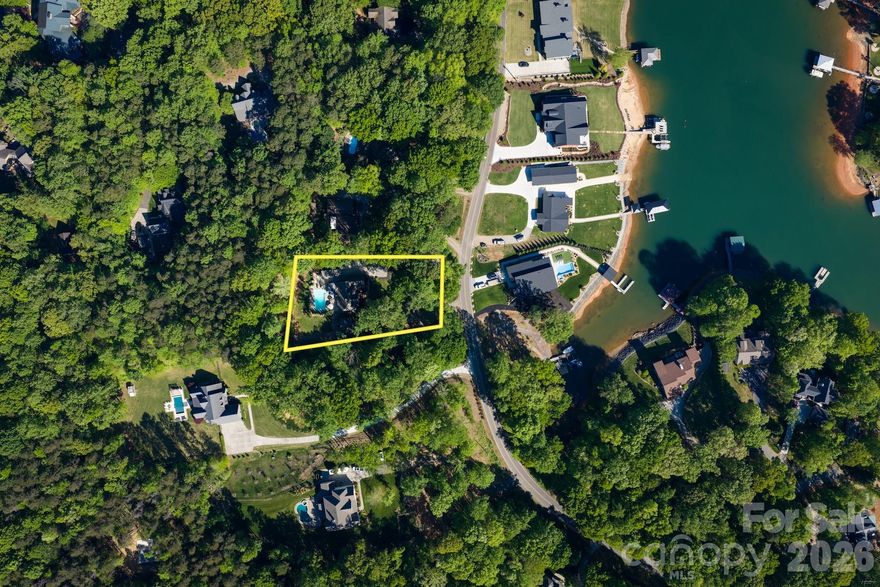 Gorgeous 5-bedroom brick home with water views of Lake Norman, offering both elegance and versatility. This thoughtfully designed home features a primary suite on the main level, along with an additional main-level suite—perfect for an in-law suite or second primary. 

The stunning two-story great room serves as the heart of the home, where soaring ceilings and a cozy wood-burning stove create a warm, inviting atmosphere full of charm and character. Just beyond, the spacious eat-in kitchen overlooks the pool, making it perfect for both everyday living and effortless entertaining. Thoughtfully designed, it features granite countertops and rich cherry-toned cabinetry that add both beauty and functionality.

Upstairs, you’ll find three well-appointed bedrooms, a versatile loft area, and a spacious finished bonus room offering endless possibilities—whether you envision a media room, playroom, or a private home office.

The detached garage is a standout, equipped with a half bath,  soaring ceilings ideal for a car lift, and an unfinished second floor ready to be customized or used for additional storage.

Step outside and escape to your own private backyard oasis—where a charming gazebo-covered wood deck invites you to unwind while overlooking the sparkling saltwater pool. Surrounded by some palm trees, the space feels like a serene, resort-style retreat perfect for quiet mornings, sunny afternoons, and evenings spent relaxing under the open sky or entertaining. 

Additional highlights include no HOA, freshly painted interior, gutter guards, and a 20 X 16 storage shed with electricity. 

This home blends comfort, functionality, and scenic views—perfect for everyday living and entertaining alike. Close to shopping and restaurants. Don't miss out on this gorgeous home!