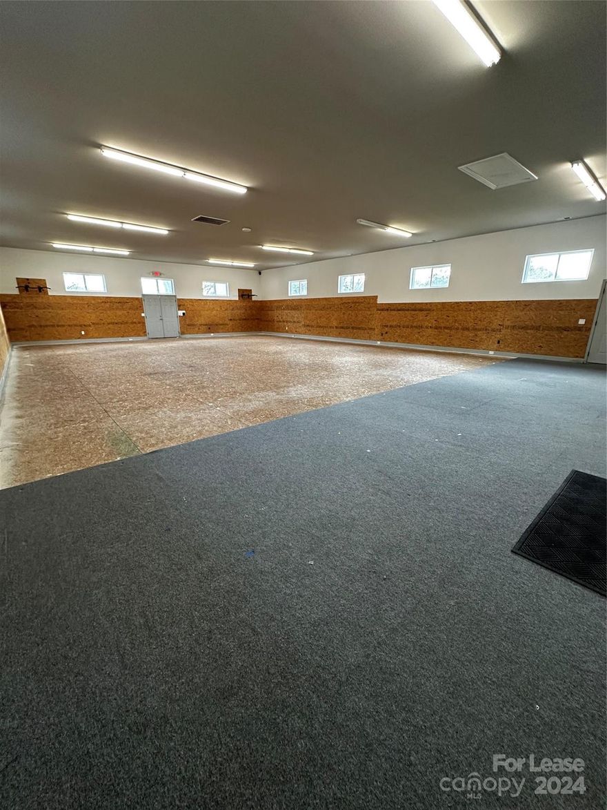Warehouse with private bathroom complete with spacious driveway. Very limited parking and includes loading ramp. Other tenants in building include real estate office and plumbing business.