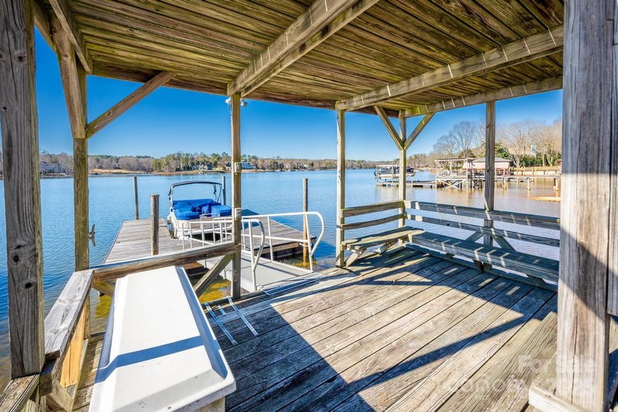 HUGE PRICE ADJUSTMENT OVER $160K!!! Beautiful 3 Bedoom Waterfront Home w/No HOA's! Pier, Double Deck Gazebo, Boat Slip & Sandy Beach Area, Breathtaking Wide Cove Views! Great Room w/Exposed Beams, Woodburning Fireplace & Access to Deck, Updated Kitchen w/Hardwood Cabinets, Granite Counters, Stainless Appliances & Eat-At Breakfast Island, Sunroom Overlooking Lake Norman w/Access to Deck, Large Primary Bedroom w/Walk-In Closet, Spa Like Primary Bath w/Double Sink Vanity, Walk-In Shower & Jetted Jacuzzi Tub, Secondary Bedrooms w/Double Door Closets, Laundry Room w/Cabinets, Full Bath w/Double Sink Vanity, 2 Car Garage w/Tons of Storage Above, Pier, Double Deck Gazebo & Oversized Boatslip, Rare Sandy Beach & Million Dollar Views.  Execllent Location, Close to Shopping, Restaurants & I-77 w/Low Iredell County Taxes & Award Winning Schools.