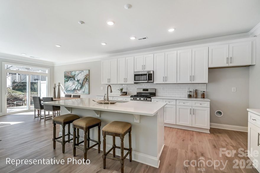 This end-unit townhome has 3 bedrooms, 2.5 baths, and an attached, expanded 1-car garage with a storage area. The garage entry with built-in drop zone leads into the open family room and kitchen. The kitchen features white cabinets, white quartz counters, a tile backsplash, and stainless appliances, including a gas range. Beautiful and durable Enhanced Vinyl Plank flooring runs throughout the main level, and all baths feature white quartz counters & cabinets. The primary bedroom, located on the second floor, includes a large walk-in closet. The luxury primary bath features a tiled shower with bench seat and semi-frameless enclosure, two separate vanities with a sink, and a linen cabinet. The second floor also features two additional bedrooms, a spacious loft, and the laundry room. Other extras include a tray ceiling in the foyer, craftsman-style trim, and stairs with composite treads & metal balusters. Visit today!