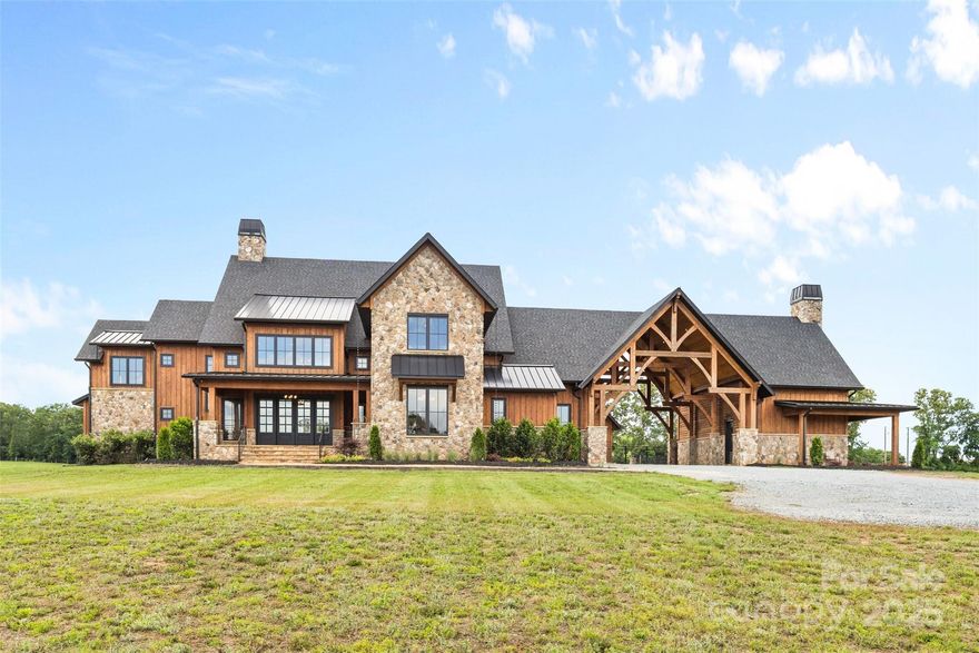 "Yellowstone Meets South Charlotte" Unparalleled Masterpiece, Newly constructed over four years, blending rustic grandeur w/ refined elegance on 63 pristine acres. This breathtaking mega-ranch, one of South Charlotte’s finest luxury properties, limitless possibilities as a private family compound or premier equestrian operation. Stunning open-concept home w/ meticulous craftsmanship, featuring a chef’s kitchen w/ a professional-grade gas range, top-tier appliances, & a striking copper farmhouse sink straight from a movie set. Guest Home Perfect for visitors / extended family, offering comfort & privacy. State-of-the-art 20-stall barn with caretaker’s quarters above, paired with a 20,000 sq. ft. standard indoor arena & outdoor paddocks encircling a serene pond w/ fountain Unwind by the expansive saltwater pool & spa, entertain at the massive fire-pit, or host unforgettable gatherings in the elegant pool house.Fully fenced & gated, ensuring seclusion amidst rolling landscapes.