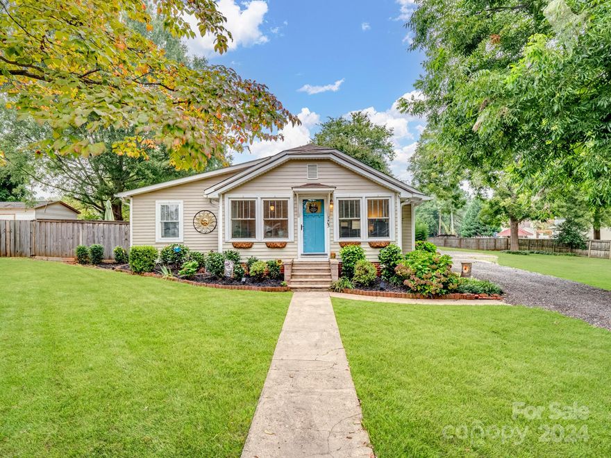 Wow! What a charming bungalow on a large half acre lot convenient to downtown Kannapolis and ready for you with a detached two car garage, storage shed and greenhouse and fenced-in yard.  You will love the hardwood floors, the finished porch, the dining room, kitchen with stainless appliances and granite countertops and breakfast area.  This home has a low maintenance exterior, great garden spot and tons of parking and there just could not be a more charming place!  Refrigerator and washer and dryer convey. Seller is offering $2500 in closing costs to the buyer! There is almost an extra lot attached to this house you won't want to miss!  Great for a "football field" or a big garden or just a nice greenspace! Don't miss this one!
