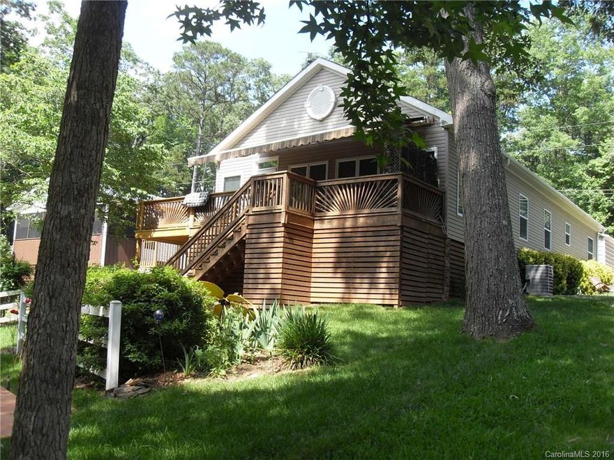 Attention to detail in the beautiful waterfront home with 9 foot ceilings. Living room with rock fireplace opens to kitchen & dining area. Lg sunroom with bamboo flooring on lakeside open to awning covered deck for relaxing evenings. Lakeside deck is perfect for summer grilling. 2 car detached garage & storage building, paved drive & walkways. Master bath with separate shower & garden tub, walk-in closets. Every detail has been thought out in this beautiful home. Private pier and floater.