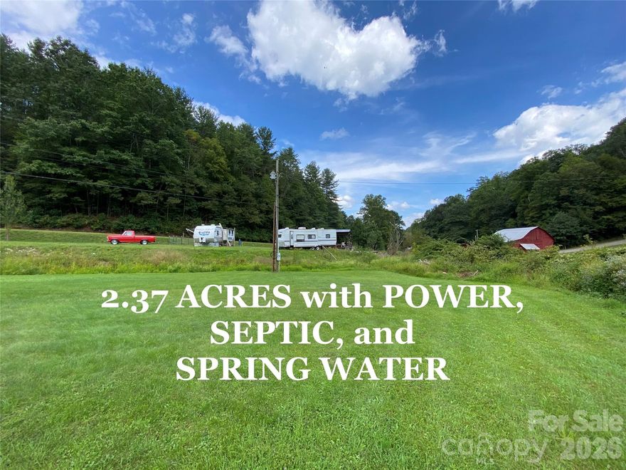 Nestled in among the mountains, back in one of the most beautiful valleys of Yancey County, you'll find this lush 2.37 acre slice of paradise. It's a blank slate but with infrastructure in place making it turnkey ready for use as a mini-farm or a place to park a camper or two. Power, septic, and spring water are in place. Most of the tract is cleared and level, with two small streams meandering through. Large open space with fertile ground ready for your gardens, and unrestricted so you are limited only by your imagination. The Bald Mountain Creek Nature Preserve is just down the road where you'll find opportunities for bouldering & miles of hiking trails. Away from all of the concrete of the city & at an elevation of over 2500' you'll enjoy cooler summers here. Escape to the country for a little R&R or bring your hobby farm dreams to life. 26 minutes to groceries, shopping, restaurants etc. in Burnsville. 50 minutes to Asheville. Trailer & campers have been removed and don't convey.