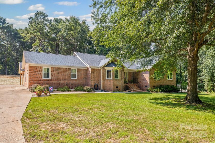 This beautifully maintained full-brick ranch offers 4 bedrooms and 3 full baths, perfectly nestled on over 2 private acres surrounded by mature trees. The home features an updated kitchen and bathrooms, a brand new roof (2025), and a spacious workshop with electrical—ideal for hobbies or storage. Tucked away in a quiet cul-de-sac, the property includes a rear patio, a dedicated gardening area, and a detached 3+ car carport. With new roof and new leach fields and a history of meticulous care, this home combines comfort, functionality, and peaceful country living.