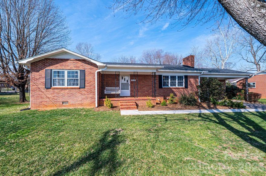 Welcome to 1425 5th St NE! This traditional ranch house is stylishly updated and ultra-convenient to the Viewmont area of north Hickory close to schools, parks, shopping, dining, medical facilities, and Lenoir-Rhyne University. Gorgeous hardwood floors & a fireplace appoint the extra-large living room. You'll appreciate the fully renovated kitchen & dining area, complete with a large center island with seating, gas range, granite countertops, stainless apliances, pantry, updated lighting and new prefinished wood flooring. The laundry room/mud room is off the kitchen & leads to the rear screened porch. Three spacious BRs all with hardwood floors plus 2 updated hall bathrooms. The primary BR offers an additional private half BA! Outside for your enjoyment are the covered front porch, open double carport, and the fully fenced level back yard. Tankless water heater. Most, if not all, cast iron plumbing was replaced with PVC. Electrical updated throughout the house.
