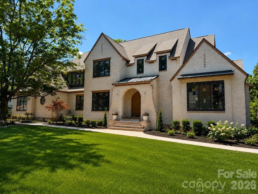 Perfectly positioned in the heart of Olde Cotswold, 2518 Danbury Street is a statement in luxury living — thoughtfully designed to deliver the level of finish, functionality, and lifestyle rarely found in Charlotte new construction. Offering over 6,200 heated square feet, this custom Barringer Homes residence blends timeless architecture with elevated modern livability, all centered around a true indoor-outdoor experience.
Designed for both everyday comfort and exceptional entertaining, the home opens seamlessly to a resort-style outdoor retreat featuring a heated saltwater pool and spa, expansive covered lounge with motorized screens and ceiling heaters, and a fully integrated outdoor kitchen. Large multi-panel sliding doors create a seamless connection between the interior living spaces and the backyard, allowing the home to live effortlessly year-round.
The main-level primary suite was designed as a private sanctuary, complete with vaulted ceilings, spa-inspired bath, steam shower, soaking tub, and designer finishes throughout. The chef’s kitchen is paired with a fully appointed scullery and separate prep spaces — delivering both beauty and functionality at a level expected in luxury homes of this caliber.
One of the home’s standout features is the intentional layout and livability: a first-floor entertaining lounge with direct pool access, dual laundry rooms, expansive secondary suites, hidden flex spaces, and a rare 3-car garage — all difficult-to-find features in established Charlotte neighborhoods.
Beyond the finishes, the home was built with a focus on quality and longevity, incorporating elevated construction standards, premium systems, whole-home wiring/audio integration, and carefully curated materials throughout. Every detail was considered not simply for appearance, but for how the home lives day to day.
Located minutes from SouthPark, Uptown, and some of Charlotte’s most sought-after schools, 2518 Danbury represents a rare opportunity to own a fully realized luxury lifestyle in one of the city’s most desirable locations. Estimated completion November 2026