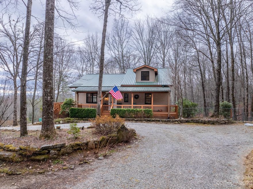 Spacious house & land for a welcoming mountain residence.  Covered rocking chair front entry porch opens to the main level great room with abundant glass doors & windows for enjoying the views & access to the deck - sunsets are magnificent!  The entire upper level is the primary suite with an abundance of closets, bath, & a quiet nook to use as you wish.  Exceptionally large bonus room on the lower level that has been used as a crafts room provides many possibilities - great for a game room