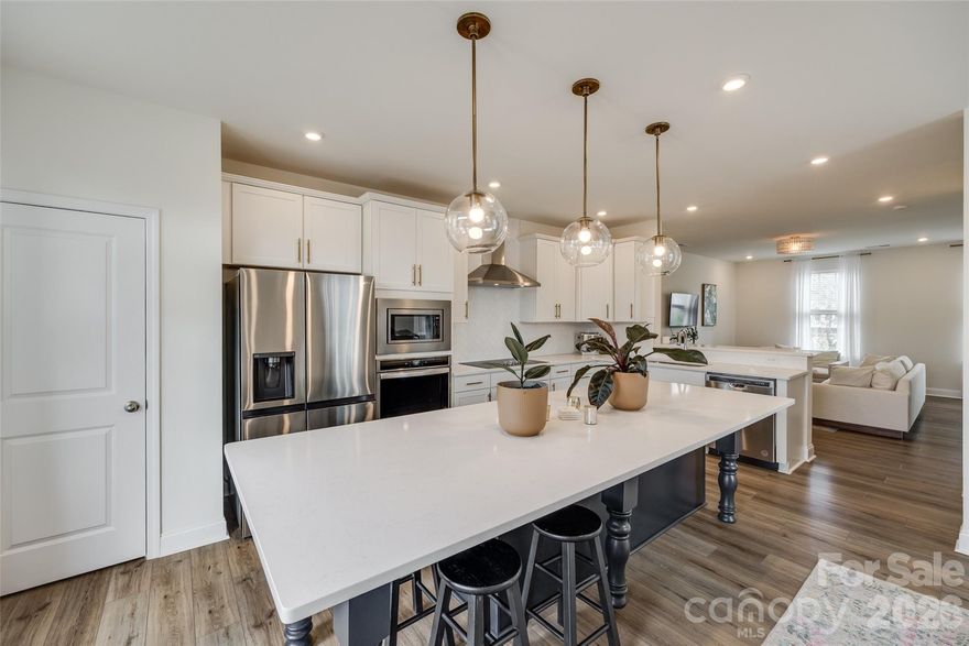 Welcome home to this freshly updated end-unit townhome, offering modern style, an abundance of natural light, and a prime location in West End Charlotte. With 3 stories, 4 bedrooms, and 3.5 bathrooms, this home offers the space and flexibility to live, work, and entertain with ease. Step inside to a welcoming foyer that leads to a spacious first-floor bedroom and full bathroom. This level also features a convenient attached two-car garage. The second level is the centerpiece of the home, offering an airy open-concept design. The kitchen is a showstopper, complete with an oversized island, quartz countertops, stainless steel appliances, and ample cabinetry. Flow seamlessly into the dining area and living room, or step out onto the private balcony. A stylish powder room completes this level. Make your way upstairs, where you’ll find a spacious primary suite featuring a generous walk-in closet and spa-like en-suite. This level continues to impress with two additional bedrooms and a laundry closet. All that’s left to do is move in and make it your own.