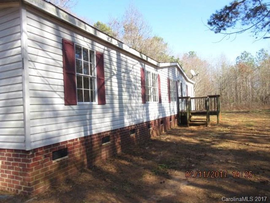 Manufactured home located on large wooded lot. Split bedroom plan, large master bath with garden tub  and separate shower.  Front porch and large deck on rear overlooking backyard. Sold as-is, where-is. Cash offers only.
