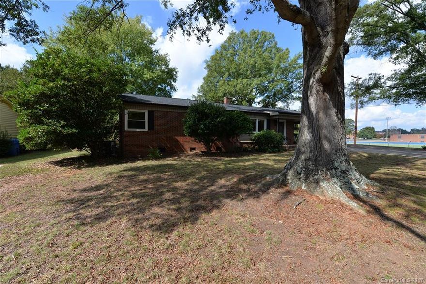 ADORABLE BRICK HOME ON CORNER LOT.  1 Car Carport. Storage Building / Workshop, Large Fenced Yard for Privacy, Recently updated, Hardwoods, Granite, Fresh New Paint Through Out, Walking distance to school.  A must see to appreciate..
