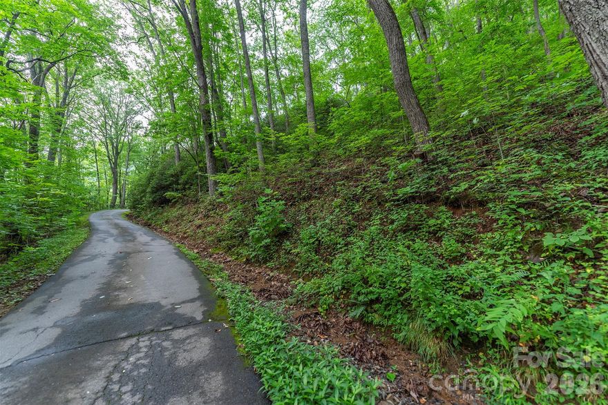 This richly wooded parcel of six lots is stunningly beautiful with expansive views possible once a home is built.  This is an established mountaintop community with a small number of very private homesites on a quiet one lane one-way paved loop road.  A haven for nature lovers and those who enjoy quietude and privacy.

Sellers have made a good faith estimate of the parcel size of the six lots based on data on Buncombe County GIS website; Buyer should confirm with own survey.
