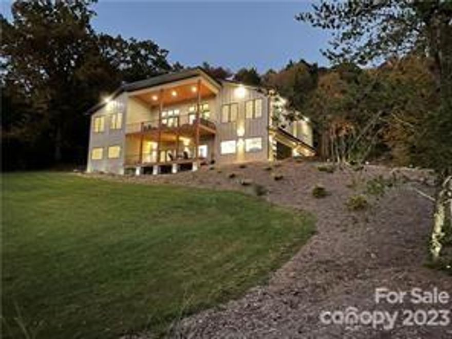 Modern-design, like new home on 1.34 acres with usable yard and incredible views. 4 miles from downtown Asheville and close to Hendersonville. The home is on privet lot with trees and year round beautiful mountains views. Hardwood flooring throughout, custom build in closets, beautiful tile, marble fireplace. Kitchen have 10’ island with two dishwashers and huge walk in pantry with counters. 3 bedrooms with vaulted ceilings separate bathrooms and spacious walk in closets. Lower level has day light 1 bedroom 1 bath. apartment with kitchenette, lower deck and separate entrance. 1015 sf. oversized 3 car garage and a lots of parking next to the house for your guests. Home features include smart siding, spray foam insulation, aluminum handrails, metal roof, energy star appliances, quartzite countertops, led lights, Anderson energy efficient windows, Trex decking board, hybrid 80 gal. water heater, hot water recirculation system, central hide a hose retractable vacuum cleaner system.