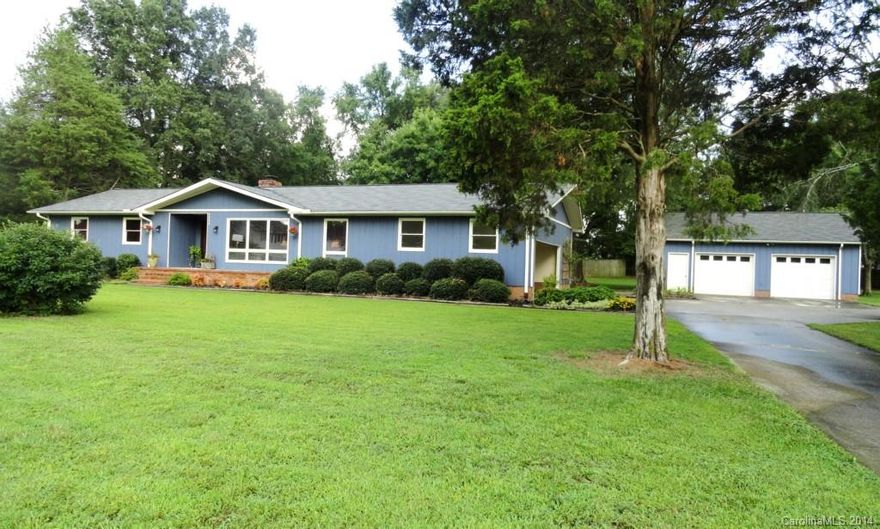 Updated ranch home on almost 2 acres! Oversized detached 2.5 car garage (30 x 26) w/ workshop, heater & a/c AND 2-car attached carport. Flat usable land w/ mature apple tree & large vegetable garden. Large wood-burning brick fp w/custom built-in cabinets & upper bookcases. Spacious DR opens to kitchen & LR. Bright LR w/ floor-to-ceiling wall of windows & ceiling fan. Kitchen: Tile flooring, built-in microwave, refrigerator, smooth-top stove & butcher-block island. New roof - 2012. Home warranty!