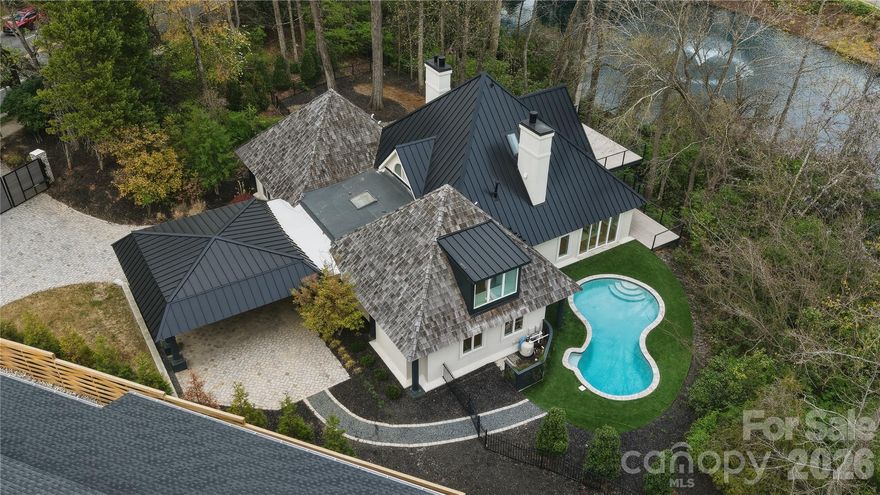 Welcome to your private sanctuary in the heart of the city—where refined luxury meets resort-style living. Perfectly positioned with tranquil pond views, this newly renovated home offers an exceptional indoor-outdoor lifestyle designed for both elevated entertaining and everyday comfort.  Expansive upper and lower decks overlook a stunning in-ground pool with turf surround, a built-in fire pit, and serene pond views—creating a true outdoor oasis. Inside, an open-concept layout is filled with natural light, enhanced by large sliding glass doors that seamlessly connect indoor and outdoor spaces. Wide plank white oak floors, custom cabinetry, and designer finishes elevate every detail.
The chef’s kitchen is a showpiece, featuring Wolf and Sub-Zero appliances, quartzite countertops, an oversized island, and a fully equipped scullery, along with a dedicated wine cellar. The main-level primary suite offers peaceful pool and pool views, complemented by a spa-like bath with dual wash closets and a spacious custom closet.
Upstairs, a second living area provides added flexibility, along with a spacious Second Primary Bedroom. Additional highlights include a sauna, a statement Isokern gas fireplace, and a new metal and cedar roof.
Located in prestigious Eastover, just minutes from Uptown, top-rated schools, dining, and shopping—with the added option for future owners to access from Wrenwood Lane—this home delivers the ultimate blend of privacy, luxury, and convenience.