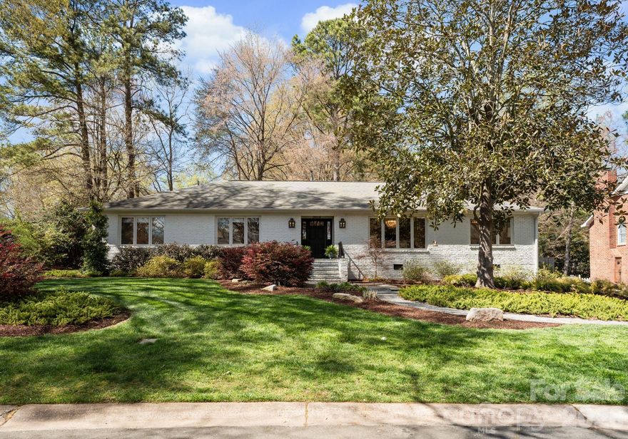 Architecturally reimagined in 2019, this exquisitely updated ranch-style home in Charlotte’s desirable Mountainbrook neighborhood offers just under 3,000 square feet of style and functionality in the open-concept layout.   Natural hardwoods newly installed in bedrooms and hallway and refinished floors in main living areas, add to the charm of this 4 bedroom 2.5 bath home in the heart of SouthPark. Interior features include coved crown molding, solid core doors, designer lighting, and a custom gas fireplace with a mantel crafted from a poplar tree sourced from the historic Duke Mansion property. Renovated kitchen with custom cabinetry, quartz countertops, waterfall-edge island, marble herringbone backsplash, and KitchenAid stainless steel appliance suite with professional gas range. The luxury primary suite features a spa-inspired bathroom with freestanding soaking tub, marble walk-in shower with frameless glass, quartzite countertops, and brass fixtures.
Walls of windows from the sunroom overlook the stately backyard; access to the backyard allows for easy indoor-outdoor private entertaining and peaceful play for furry friends, entertaining with friends and family of all ages. Professionally designed landscaping (2021) includes a bluestone patio, custom hardscape, irrigation system, and low-maintenance turf (2025). Major system updates include new electrical and plumbing (2019) and new HVAC system and ductwork (2023). This home is move-in ready for anyone who wants to enjoy maintenance free urban living in the heart of SouthPark. Convenient access to shopping, dining, and schools. Membership to the Mountainbrook Swim & Racquet Club offers access to tennis, pickleball, swimming pool, playground, track, and volleyball court.