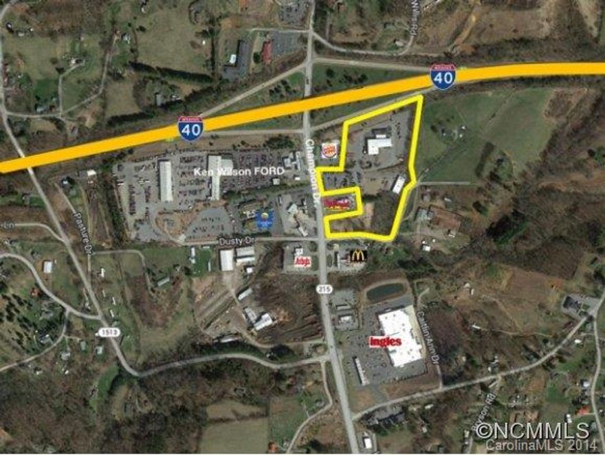 Commercial tract of 4 acres with excellent I-40 visibility. 19,000-square foot building (former car dealership) has no value. Last commercially developed exit before Tennessee. Zoned for many commercial uses. One of four tracts available. Portion of PIN.