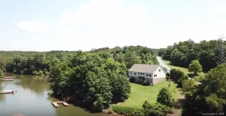 WATERFRONT home with dock and year round lake view.  Enjoy the serenity of Lookout Shoals Lake.  One hour from Charlotte.  Its an easy stroll to your lakeside deck and floating dock. Enjoy your lake view from the balcony off the master bedroom,  the sunroom, the living room, or the kitchen.  Upon entering the front door you will note the hardwood floors, the 9 foot ceilings, and the spacious living room with gas fireplace.  Large kitchen features granite counter tops, stainless steel appliances, walk in pantry, and island.  Separate dining area and tiled sunroom complete the main living area.  Master suite has large closet, balcony, soaking tub and walk in tiled shower.  Full walkout basement has half bath and large finished den/recreation room. Plumbing installed for kitchen and to add shower to existing half bath.  This would make a nice in-law suite. Concrete safe room. Unfinished 2 car garage with room for 4 cars. 1500 sq ft of storage available in walkup attic.