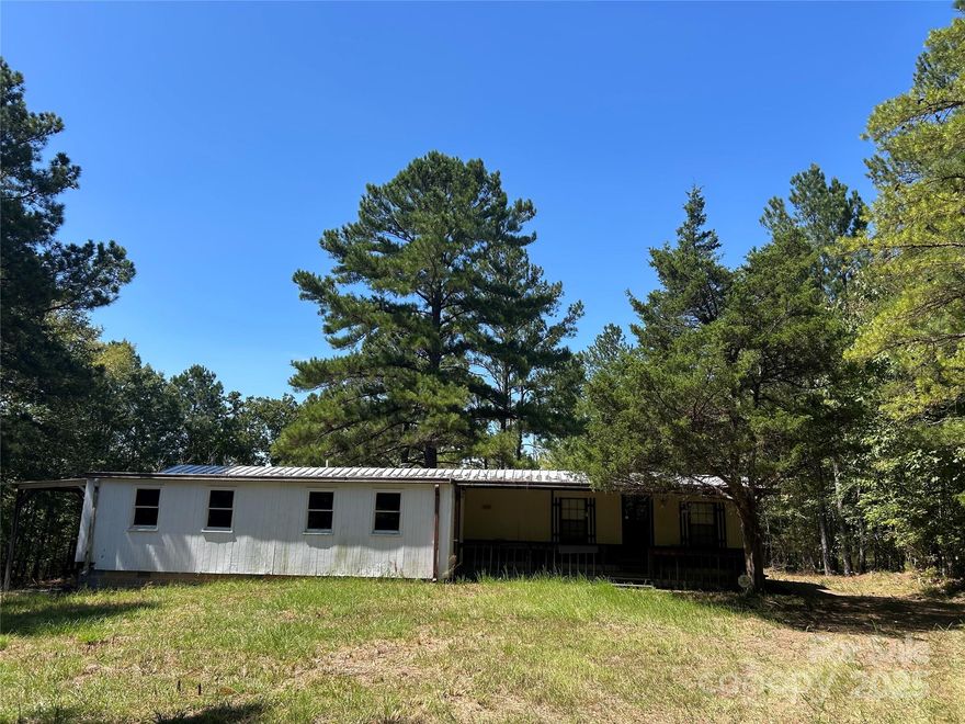 Almost 43 acres of prime hunting and recreational property with a bonus single wide mobile home(As-Is). RV hookup behind the mobile home on a fenced in yard.  Property is set up to hunt with two nice food plots and half of the powerline on the back property line. Good road system throughout provides access to almost every portion of the land. Timber is about half planted pine and half hardwood with a couple of small creeks that connect in the middle main body of the tract. Access is an old county dirt road runs through the front edge of the tract as shown on the plat. Come make memories on this private little piece of paradise.