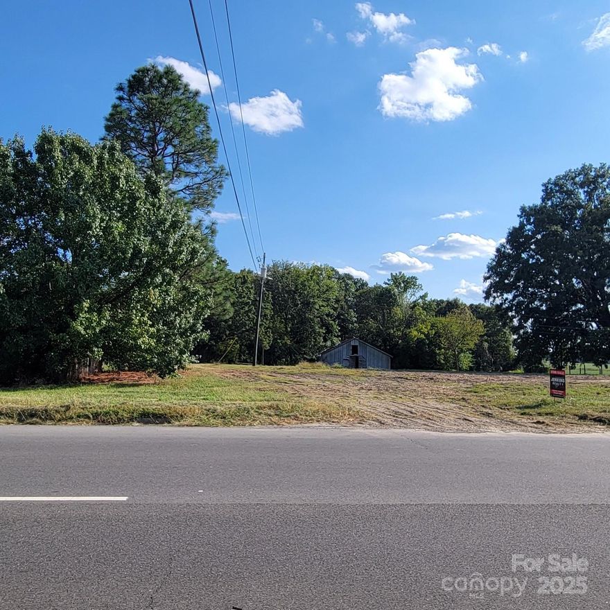Great location in Wingate, NC with approx 128' frontage on 4 lane Highway 74.  Two lots totaling 1.91 acres.  Open area in front and wooded area on back side of property. Previously single family dwelling has been removed but there is a 36x36 barn on the property. Current zoning is Highway Corridor Wingate-AI1. Lot depth is approx 452' from front to back.  Public water connected, septic tank installed & natural gas service available at street.    Endless possibilities for development.  Survey available.