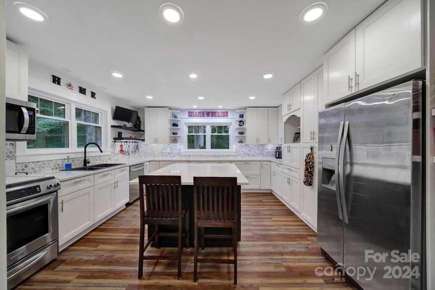 New Price Adjustment! Completely renovated one of a kind craftsman style home on 2.5 acres. Step into the grand entryway of this beautiful open concept home. Impressive vaulted ceiling sunrm w/tons of natural light. Home boasts built-ins that won't disappoint. New flooring throughout. Chef's kitchen features custom soft close cabinetry, pull out storage, quartz counters, large island, built-in pantry, ss/appliances, gas cooktop & opens to the gigantic dining rm w/built-in serving station. Spacious vaulted ceiling great rm. Primary suite on the main w/custom walk-in closet. Upper level will blow you away! Many endless possibilities with the unique additional bedrms & flex spaces. Enjoy relaxing in the hot tub on the double level deck which overlooks the private wooded sanctuary. Fenced area for pets. 2 sheds w/new roofs. Cozy trex decking front porch. Freshly stained cedar siding. New water softener. Rinnai tankless hot water heater. Leafguard Gutter System. NO HOA!