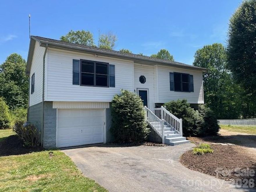 Well maintained split foyer in the Gamewell area of Caldwell County. Main level features open floor plan with beautiful new flooring. Den offers gas log fireplace. Kitchen features electric range, microwave, dishwasher & refrigerator. Both bedrooms also have new flooring. Bathroom features tub/shower combo and tile floor. Basement offers bonus room that was used as a bedroom, but ceiling is just under 7ft. Septic permit is for 3 bedrooms, and current owner was using this room as a 3rd bedroom. That room is finished and heated. Large 24x30 metal garage has its own power meter and features a 9,000-pound hydraulic (Rotary Lift) ideal for the car enthusiast plus a woodstove to keep your workshop/garage warm. More recent updates include a new back deck overlooking the yard, new rear storm door, mostly new interior paint, 6-month-old side by side refrigerator, some new lighting and more. Move in ready and waiting for a new owner. In 35 minutes, you can commute to Lenoir, Morganton, Valdese, Blowing Rock, Hickory and many area events.