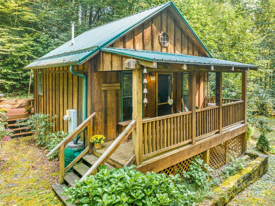 Wonderful get away cabin on the pristine Laurel River. Locally known as the Trout Shack - you can walk out your door to some of the best trout fishing in the area. The cabin has a fireplace & power, no septic or well, gravity shower with rain catcher, & composting toilet. The cabin was built as guest house near the river with a main home site up above on a beautiful knoll. The property is just beautiful with lots of trees filtering the sunlight, a road in place from top to bottom, and multiple paths to the river access. The lot features a wonderfully flat area that would make a perfect building site. You could stay in the cabin while you build your dream home in Laurel River Crossing - close to Marshall, Hot Springs, TN, and all that WNC has to offer. Just minutes to the Laurel River trailhead or you can hit the river on the property! Snatch this one up soon and enjoy the crisp fall of WNC from your fishing cabin front porch! And yes - the cabin can be used as an STR!