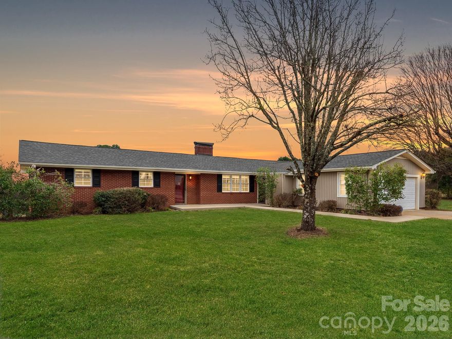 Finally, an affordable horse farm conveniently located only 11 minutes from Tryon International Equestrian Center. Set on 6.25 acres of usable, level land with fenced pasture, 2 stall barn w/tack/feed room, run-in shelter area, and a round pen with sand/stone dust footing. The 2,202 sq ft house offers plenty of space with a massive family room featuring a vaulted ceiling and beams, built-in bookcases and wood burning fireplace. The large living room with gas fireplace opens onto the kitchen which has its own dining area in addition to the separate dining room which the current owner used as an office. 3 bedrooms and 2 full bathrooms. New roof in 2022. Beautiful hardwood floors that were recently refinished plus new flooring in the family room, dining room and one bathroom. Interior painted in 2022; new water heater 2022. 
The barn was added to the property just prior to the seller's purchase in 2022. Seller had a large overhang shelter/run-in area constructed on the front of the barn, and installed water, electric and bluestone mix footing. Part of the shelter could easily be converted to a 3rd stall. Stalls are matted. The round pen was professionally graded. Large, recently stained deck on the back of the house is a great place to enjoy the view of your horses. 
The unfinished basement with interior and exterior entrances offers an additional 1,445 sq feet of space. This property gives you the best of both worlds - expansive, unrestricted land yet you are only minutes away from shopping/dining in Forest City with the convenience of Tractor Supply, Lowe's, Walmart and more. Quick ride to Highway 74 if you're heading to Charlotte or Asheville.