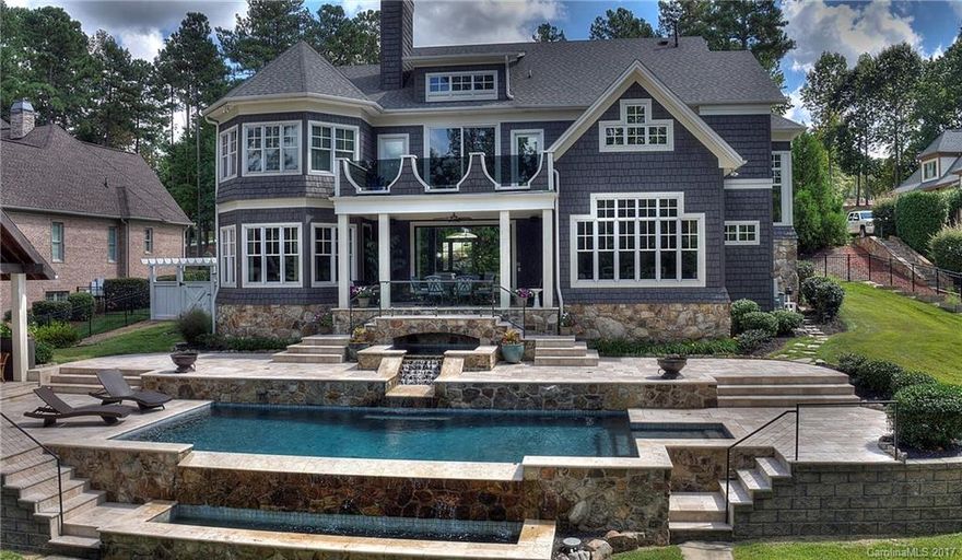 Absolutely stunning Nantucket cedar shake waterfront home in desirable Baycrossing subdivision. Beautiful & unque design features rustic/industrial theme, gray color scheme, chrome fixtures, open concept, porcelain tile, rustic hardwoods & marble tops. The master bath is an award winning design w/radius shower, glass & porcelain tile. Relax by the breathtaking infinity edge gunite sport pool w/travertine decking. Titan Custom Builders incredible design & builder/listing agents personal home.