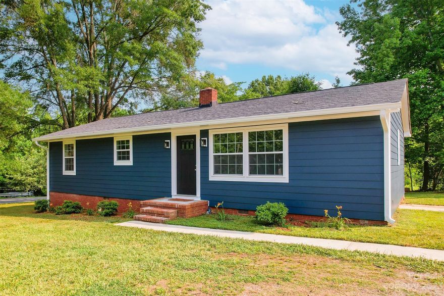 Fully remodeled, one story home with NO HOA! Enjoy a large .46 acre corner lot in the heart of Mint Hill- close to shopping & restaurants with easy sidewalk access. No stone was left unturned w/ updated electrical, plumbing, new windows, HVAC, water heater, siding & custom finishes throughout. Enter the gorgeous white Kitchen to find soft close cabinetry, black accents, white subway tile, Stainless Steel appliances and Quartz countertops! The gleaming original hardwoods lead you to the living room w/ a TON of natural light. The focal point is the stone surround electric fireplace w/ reclaimed wood mantle. Enjoy the convenient split bedroom floorplan . Enter the primary bathroom w/ barn door, porcelain flooring, walk-in shower & dual vanity sinks w/ granite counters. Every closet has custom components! The secondary bedrooms share a full bathroom w/ porcelain tile flooring, soaking tub/shower w/ subway tile surround!  Head out back to relax on the deck & enjoy the peaceful wooded lot!