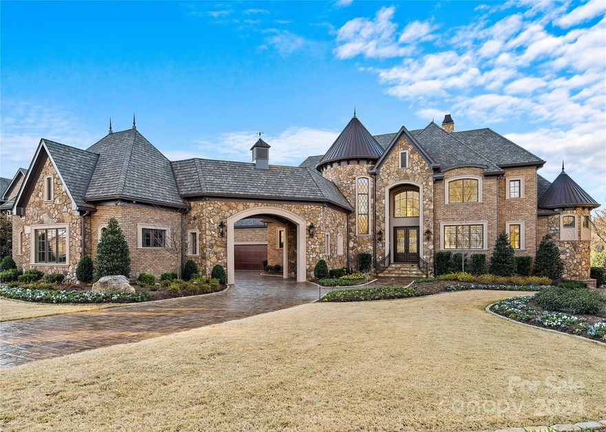 Breathtaking waterfront estate with saltwater pool and spa, on private, lush grounds; in the sought-after gated Skyecroft, showcasing impeccable craftsmanship and luxury throughout. The main chef's kitchen includes top-tier WOLF and Sub-Zero appliances, an ASKO dishwasher, expansive island w/ elegant quartz counters, etc. A second ASKO dishwasher, and built-in MIELE coffee maker in the dining room.  Porcelain floors & crystal chandeliers highlight the turret staircase. An elevator provides seamless access. The owner’s suite features a grand turret shower w/3 heads, quartz vanities, a vanity room, & Bain soaking tub, w/ dual closets. Coffered ceilings & deep wainscotted moldings w/LED lights... The terrace w/ auto screen, and the basement w/ a full kitchenette, dining, home gym, theatre, a full bath & wine cellar, etc. 2 studies; one that can be a 6th bed suite both lead to the pool and spa, outdoor gourmet kitchen, multiple verandas, pond, etc. No stone left unturned. Wow!