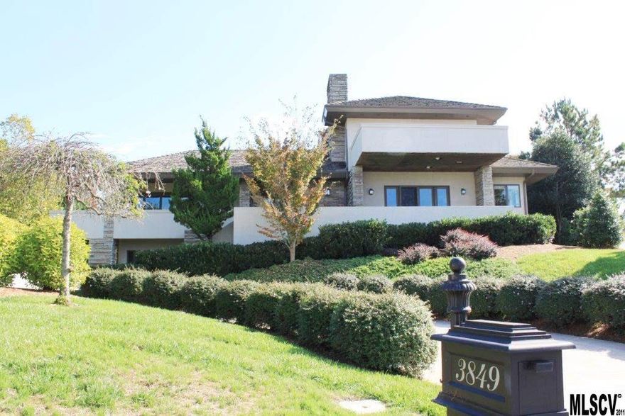 Premier Lake Hickory neighborhood, Governor’s Harbour, w/lake access area. Opulent architectural style/striking contemporary w/wood shake roof & Grandfather mountain stone exterior. Truly designed for today’s executive lifestyle. Dramatic leaded-glass entry w/marble foyer & beautiful finishes. Walnut staircase, great room w/great expanse of windows featuring stone fireplace/hardwood floors opening to wrap deck/easy open feel w/ formal dining and designer kit in 2011 w/chopping block island/gas cook top/Sub-Zero Refrig /quartz counters/eat in dining w/grand view of manicured rear yard & access for entertaining or play. Master suite on main w/spectacular Lake views from front deck/fireplace/large closet/relaxing rear covered porch. 2nd level features bdrms & upscale study/walnut inlaid walls/hdwd/built in bookcases/FP/marble hearth & balcony. Lower lvl for parking/storage/future exercise room. Impeccably maintained. 4BR/4.5BA. Abundance of living space in beautiful contemporary.