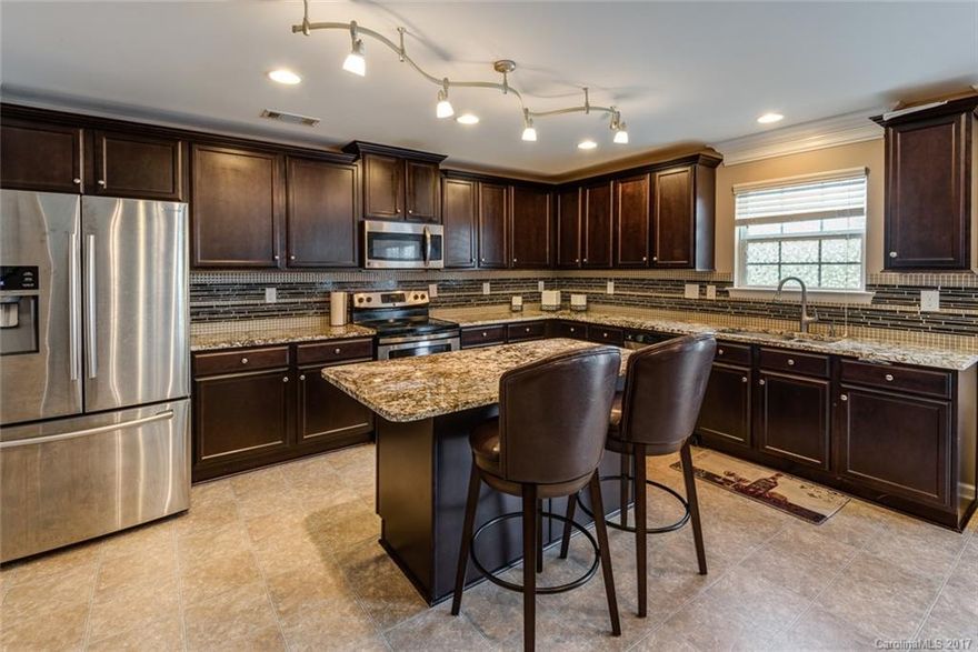 Fabulous open floor plan with over 3,100 sq. feet.  Huge open kitchen with upgraded granite and backsplash, large island, stainless steel appliances, walk in pantry and refrigerator conveys.  Office or den on main with french doors.  Spacious family room with gas fireplace and Formal Dining Room. Four bedrooms on 2nd floor and large loft area. Three full bathrooms. Convenient to 485 and I-85 and tons of shopping. Move in today to this lovely family home built in 2015!