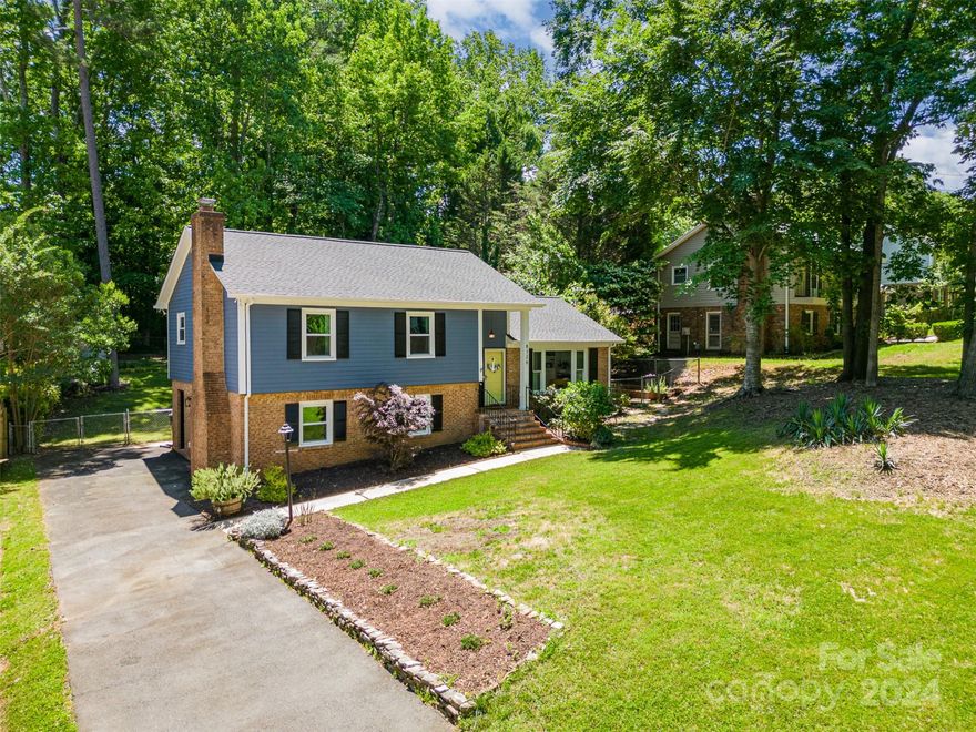 A charming, classic Charlotte split level home. Close to Matthews, McAlpine Greenway, and easy drive to Uptown. You will love the expansive fenced backyard with whimsical stone paths, raised garden beds, fire pit, large deck, and natural area. Inside, the main level was completely redone in 2021 to open up the space, including a full kitchen remodel with huge island - a favorite place to gather with friends and family. Another living area downstairs, along with a private bedroom + full bath with separate keypad entry. Primary suite + 2 bedrooms and additional full bath upstairs complete the space. Upgrades in addition to the remodel: new roof with 10-year transferable warranty ('24), new triple pane windows throughout ('23), new quartz bathroom counters ('24), encapsulated crawlspace w/dehumidifier ('20), exterior paint including deck ('23), Ring doorbell + Nest thermostats & smoke/CO alarms ('19), and shed ('20). Rainsoft whole-house water softener added by previous owners.