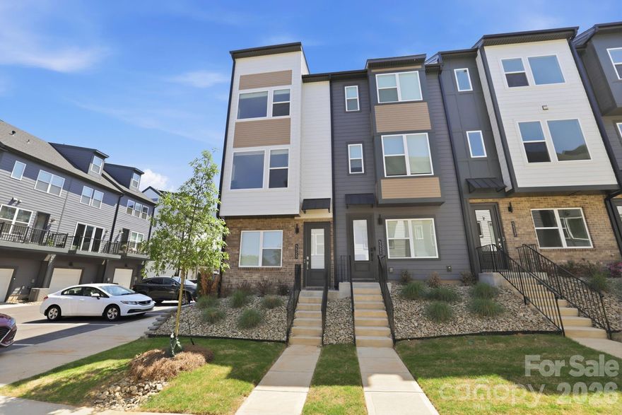Welcome to the NEWLY gated townhome community of Southmont. This stunningly appointed home exudes effortless sophistication, designer quality living with todays high tech conveniences. Interior End-Unit with tandem 2-Car garage and third open driveway space,  extra storage and electric vehicle plug-in. Beautiful oak wood stairs and railings throughout welcome you in. Enjoy an Incredible light filled living space with Seamless flow throughout the main living area all enhanced with LVP flooring. Dreamy kitchen offers quartz countertops, subway backsplash, island w/seating, touchless faucet, premium Cafe SS appliance package, Samsung French door refrigerator with beverage center, and spacious pantry. Adjacent balcony offering the perfect place to unwind or start your day. Owners suite features dual sinks, quartz countertops, tile flooring, and spa style shower tile/flooring, and dual closets. Additional secondary bedroom with own en-suite bath and hall laundry room rounds off the upper level. Third floor offers endless possibilities for flex space, private office retreat, play area, or additional bedroom with private bath. Southmont offers a fully gated community with gate cameras, customized guest passes, a Pickleball Court, & walking distance to the Archdale Light Rail Station. Short drive to everything Charlotte: 15 minutes to SouthEnd, 10 mins to Uptown City Center, 10 mins to SoutPark & 20 mins to CLT Airport. All appliances included, better than NEW. Call today for your personalized tour.