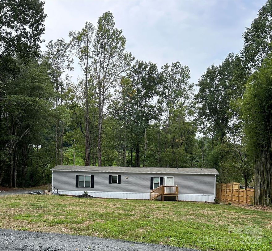 Beautiful upgraded Clayton manufactured single wide home on private lot just outside of Rutherfordton. This home features a split bedroom plan with primary suite with an oversized tub for relaxing. The kitchen features a breakfast bar and stainless steel appliances. Step out onto your deck and enjoy the private backyard overlooking your very own bridge over your creek. The outside is where this property really shines! There is an outbuilding and plenty of space for animals or a garden. Bring your personal items and move in, as all the furniture is included. Per the seller: new gravel driveway, new septic tank, new waterlines from the road, updated the outbuilding and installed a privacy fence.