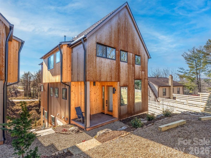 Modern Scandinavian design meets everyday comfort in this newly built Montford home. Clean architectural lines and a bold mix of corten steel and cypress siding create a striking, low-maintenance exterior. Inside, natural light fills the open-concept living spaces, designed for both relaxed living and easy entertaining.

Thoughtful finishes elevate every room—designer tile, custom cabinetry, a wood stove, and curated fixtures that feel refined yet approachable. The layout offers 4 bedrooms, 3.5 bathrooms, a dedicated flex or office space, and a second living area, providing flexibility for work, guests, or quiet retreat.

The fully finished daylight basement adds valuable versatility with its own private entrance, wet bar, and stackable washer and dryer—ideal for multigenerational living, a guest suite, creative space, or potential short-term rental use (buyer to verify).

Located in Montford, just minutes from downtown Asheville and the River Arts District, the home offers convenience with a quiet neighborhood feel. Designed by All Clear Design and built by Green Light Custom Homebuilders, it delivers the craftsmanship of a custom home—without the extended timeline.

Next door, 173 Houston Place (MLS #4325651) is also available, offering a mirrored layout and the same high-end finishes. Together, these side-by-side properties present a rare opportunity for buyers seeking flexibility, investment potential, or the chance to choose your neighbor.