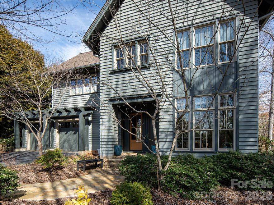 Stunning upscale custom home on a spacious corner lot! This one of a kind home was designed by a respected local architect as his personal home! The exterior detail and finish harkens back to the original homes of Ashevilles historic Montford neighborhood while the interior offers a modern flair with clean lines and timeless materials. The main level is open and filled with natural light! Upstairs the bedrooms are spacious with ample closet space, well appointed bathrooms, and a coffee bar. don't miss the large private deck off the primary bedroom! The finished lower level is ideal for a guest suite, office, den, or library and also offer huge storage areas! Outdoor living spaces include a charming covered veranda, deck, stone patio with fire pit within the large fenced rear yard! Close to the lake, clubhouse, trails, boating, concerts, events, pickle ball, tennis, and everything else Biltmore Lake has to offer!