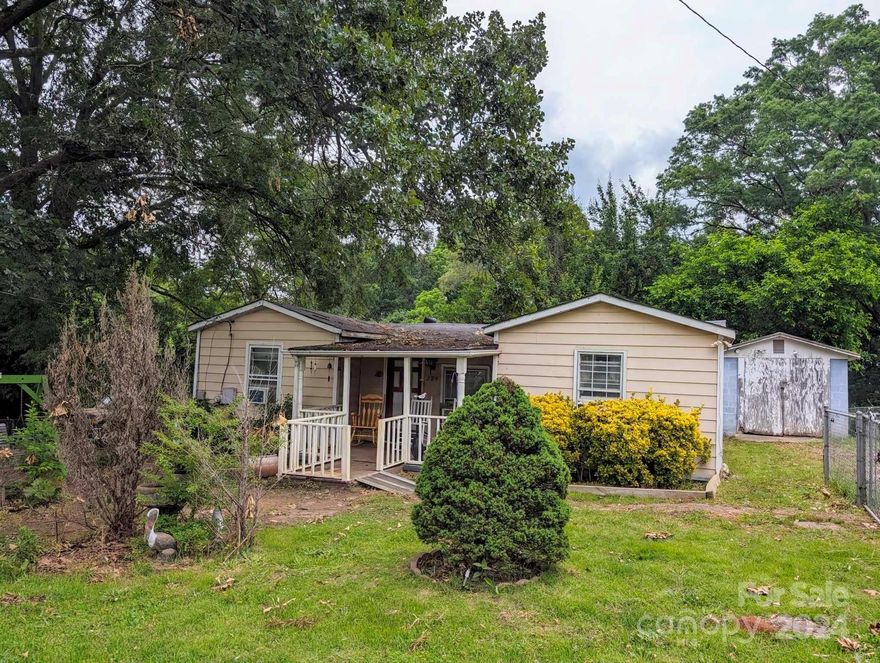 Investment opportunity! This home is being sold as is and will need full rehab. This home offers so much potential with a fenced in yard and multiple outbuildings/workshops.