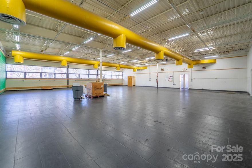 Prime commercial opportunity in the heart of Franklin, NC! Situated on 2.29 acres, this former U.S. Post Office offers approximately 8,809 sq. ft. of single-level space with exceptional flexibility for office, retail, warehouse, showroom, or mixed-use needs. The front portion of the building (approx. 2,135 sq. ft.) includes a tiled lobby with reception, six private offices, and a conference/waiting room. The expansive rear section (approx. 6,430 sq. ft.) features a large open flex area, two offices, two restrooms, break area, storage room, mechanical room, and modular cubicles that may remain or be removed. No load-bearing interior walls offer easy reconfiguration options. Exterior features include a three-bay loading dock with power lift, paved parking for approximately 58 vehicles, four HVAC units, metal carport, outdoor storage room, and fire alarm panel system. Located along a highly traveled corridor with excellent visibility and access, close to dining, shopping, farmer’s markets, and year-round festivals. City water, sewer, and fiber internet to building. A rare opportunity to secure a prime, high-traffic commercial asset in Franklin’s core business area.