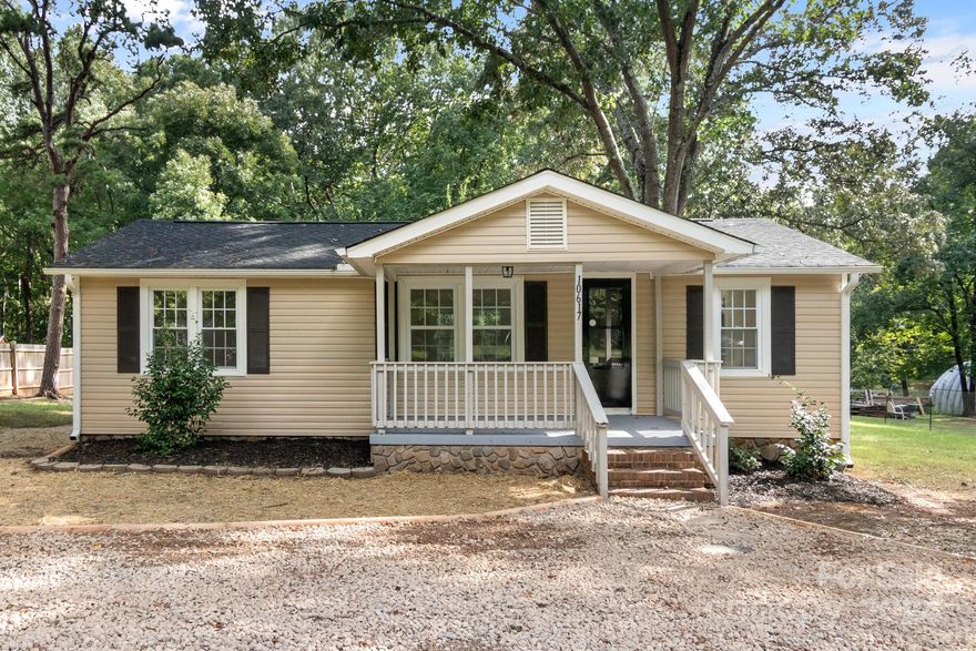 Location, location, location! This CUTE 2 bed, 1 bath home is only minutes from downtown Waxhaw with over .60 Acre lot!! Walk up the stairs onto the spacious covered front porch! From there, walk into the home onto NEW Designer Shaw LVP flooring throughout the entire home! OPEN FLOORPLAN!  Kitchen is BEAUTIFUL w/white shaker cabinets, granite countertops, NEW SS Appliances and Island w/bar seating! Room for entertaining w/breakfast nook & dining area! LOTS of room for storage & pantry shelving in the HUGE Laundry Room off the kitchen! Both bedrooms are ample in size and share the one hall full bathroom w/single granite vanity and walk-in shower. Enjoy sunsets and watching for wildlife off the back deck! Lots to love!! Come see it today!