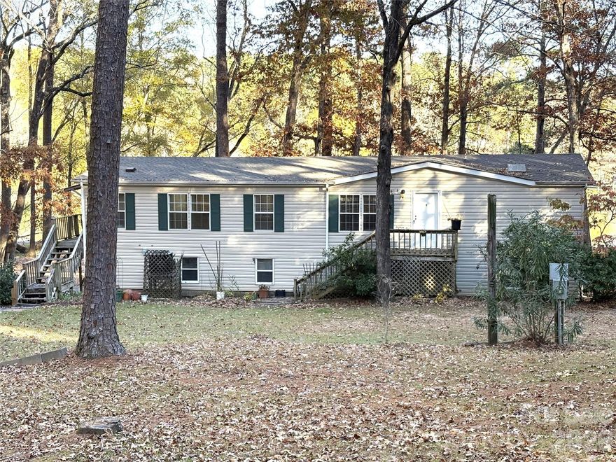 Great new price! It's time to make your dream of a waterfront home a reality!

You will experience easy lakefront living in this charming 2002 Horton manufactured home on beautiful Lake Wateree. Offering 3 bedrooms and 2 baths split floor plan, this well-maintained retreat features an open living and dining combination, plus a spacious kitchen with a breakfast area and bar—perfect for gatherings and everyday convenience.

Relax and unwind with two inviting outdoor living spaces: a screened porch on the main level overlooking the water and a covered porch on the lower level for year-round enjoyment. The walk-in crawlspace provides an impressive workshop area with room for tools, hobbies, and even vehicle storage, complemented by an additional detached carport.

Enjoy lakeside activities with your own stationary dock—ideal for fishing, boating, and sunset views. Whether you're looking for a weekend getaway or full-time residence, this Lake Wateree property delivers comfort, functionality, and the relaxing lake lifestyle. Let the waterfront views welcome you home!