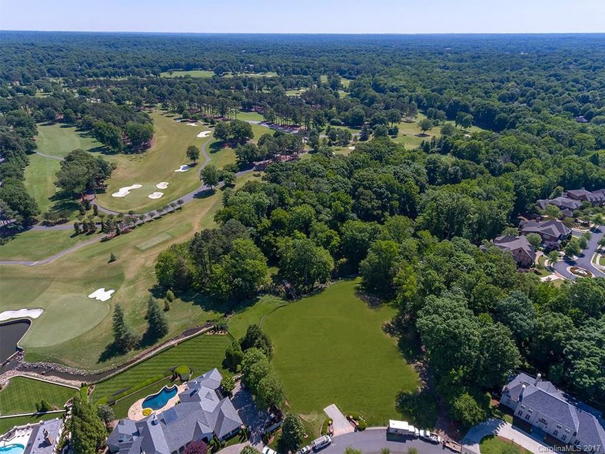 2.5 acre estate size lot located in the gated neighborhood of Seven Eagles, home of the 2017 PGA Championship. This future home site offers spectacular views of the 7th green and one of the only lots that offers direct access to the golf course. Build your dream home in one of Charlotte's premier neighborhoods.  The property extends beyond the wood bridge and the future homeowner will have the ability to remove trees to further open up views.  Privacy, luxury and security.
