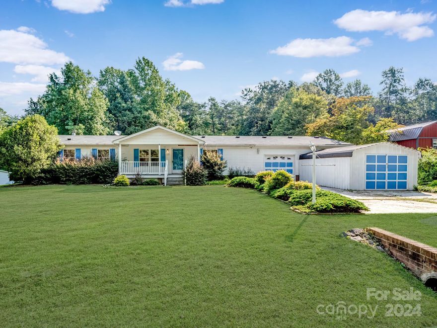 Discover serene country living on this expansive 1.3-acre property. This spacious home is bathed in natural light and features vaulted ceilings, an open formal living and dining area, and a cozy family room with a wood-burning fireplace. The sunny kitchen, equipped with an island and breakfast area, offers ample workspace. The large primary bedroom includes a shower, dual vanities, and built-in cabinetry, while each secondary bedroom has its own walk-in closet. Recent upgrades include a new well bladder (2022), a 5-year-old AC unit, and a roof replaced in 2012. Enjoy outdoor living with Trek Decking on the front porch and a spacious deck overlooking the private backyard. The property also boasts a wired storage shed, an oversized two-car garage with cabinetry, and an enclosed carport for additional storage. Built with quality craftsmanship, this home is being sold as-is, offering a unique opportunity to personalize your dream home.