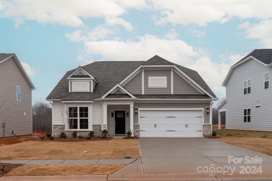 This 1.5-story home features an open layout with most of the living space on the 1st floor. 2nd floor rec rm, bed & full bath. Off the foyer is a guest bed & full bath plus Flex rm w/closet. KIT has white perimeter cabs w/ a stained island, GE SS app w/ 36" gas cooktop, extraction hood & wall oven/microwave, quartz counters, tile backsplash, trash pullout, drawer stack under the cooktop, walk-in pantry plus a Butler's Pantry w/ upper & lower cabs.  Rear covered porch; Family rm has vaulted clg. First-floor Premier Suite w/ tray clg & WIC; bathroom w/ quartz counters, stone grey cabs, large tiled shower w/ bench, tiled floor & Moen brushed nickel plumbing fixtures. Secondary baths have quartz counters, tiled flooring and Moen brushed nickel hardware. Hardwoods throughout most of the 1st fl w/ tile in full baths & laundry; stairs have oak treads w/ modern straight wrought iron balusters. Planned pool & tot lot. 2-1 mortgage rate buydown available from seller when using preferred lender.